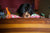 boy peaking holding a pillow looking at his plastic toys