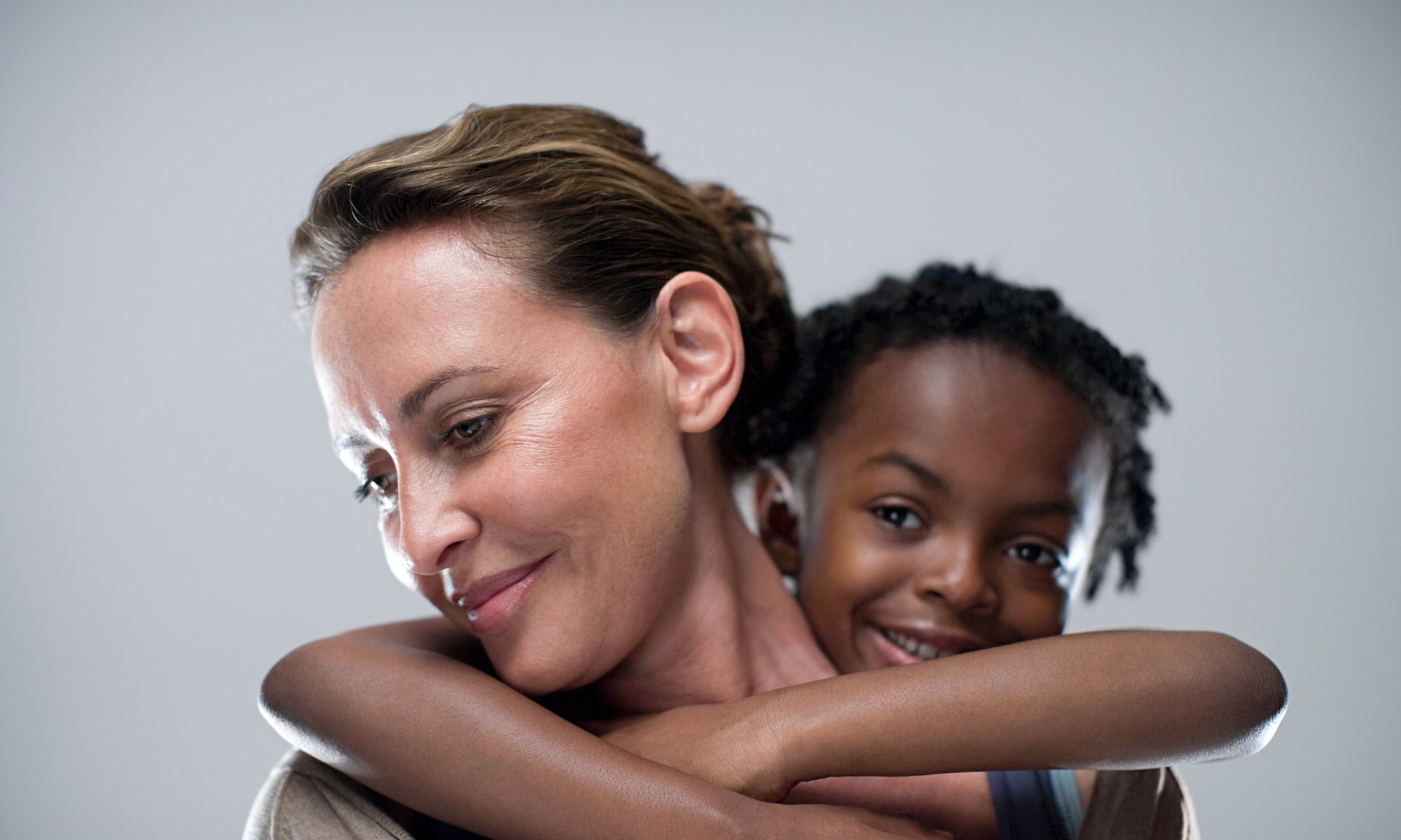 A kid is hugging its mother