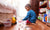 little boy sitting on bedroom floor and playing with toys