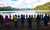 Group of people praying near river side