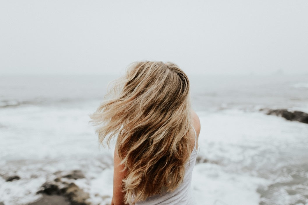 rear view of lady looking at ocean