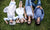 family members lying in the field wearing solar eclipse glasses