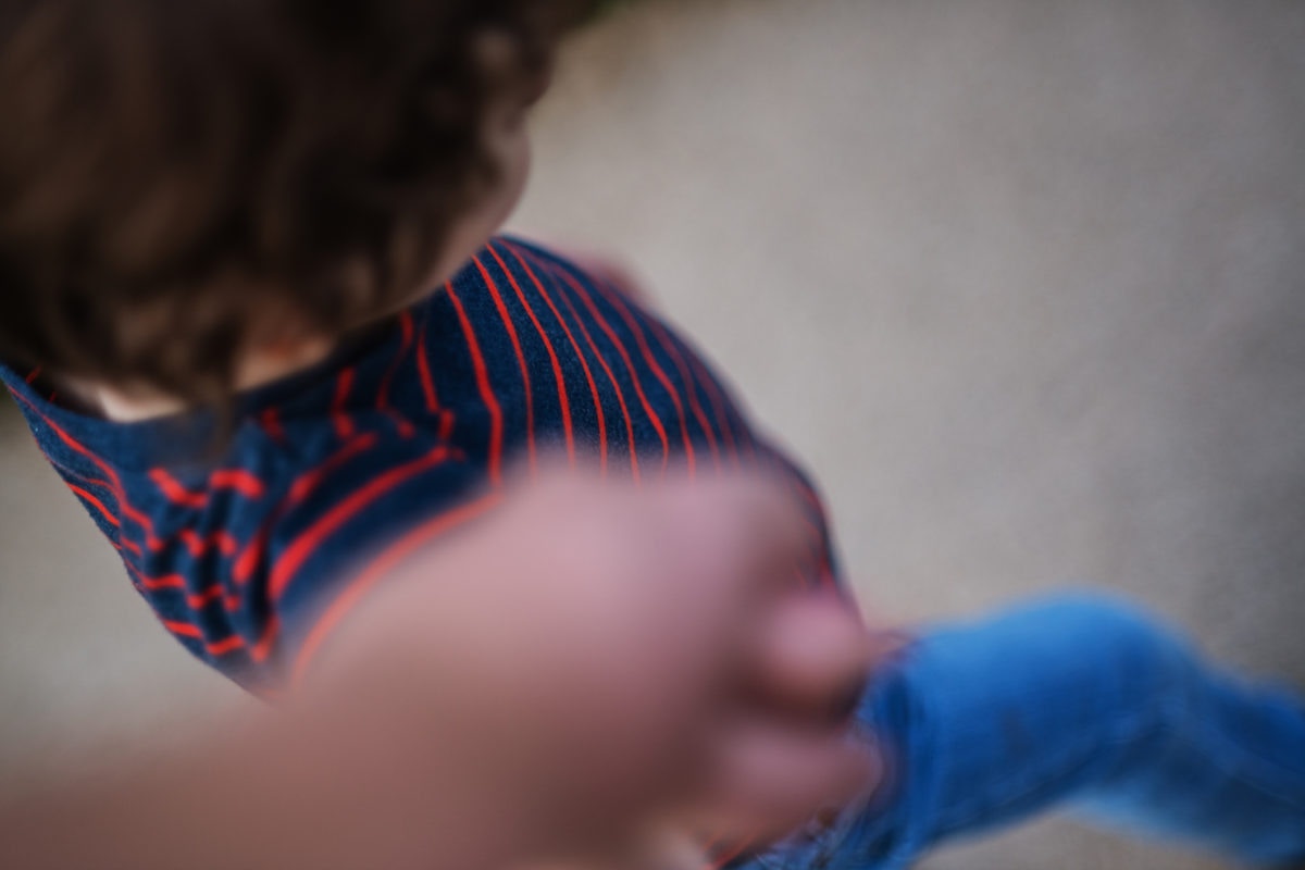 Young boy walking hand in hand with his father