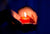 Hand holding a burning candle in dark