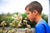 boy smelling white dandelion