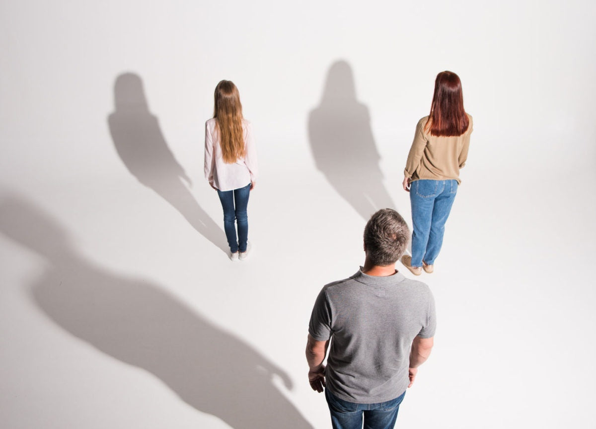 mom and woman and daughter looking at a white wall