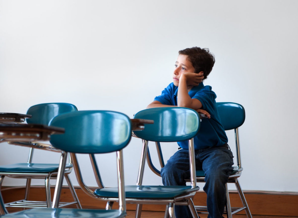 boy at desk looking up