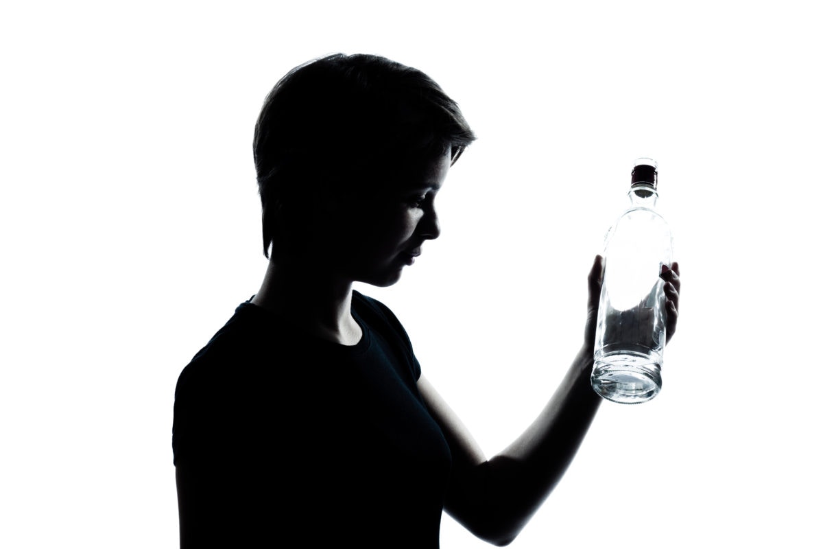 black and white image of a boy holding a water bottle