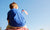 Boy sitting on a shoulder by holding US flag 