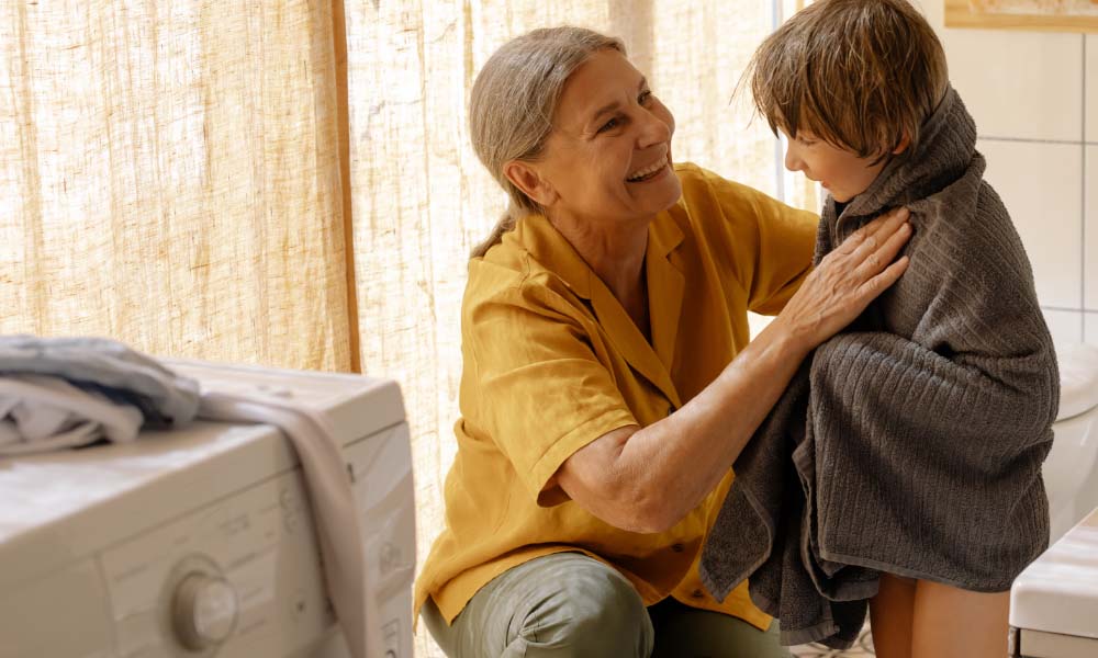 a grandmother drying her grandson