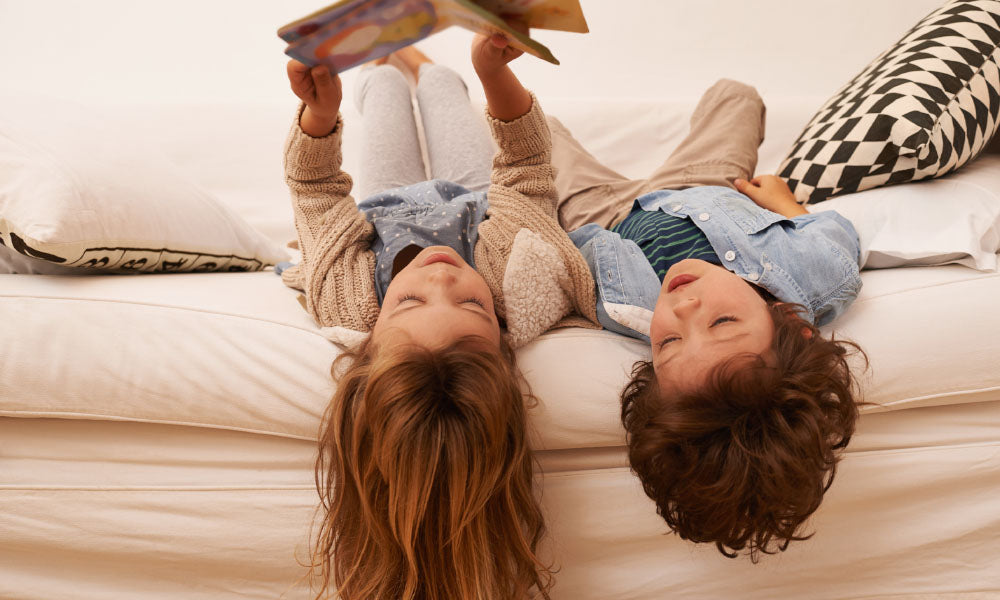 boy and girl looking at a book