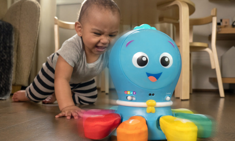 boy playing with baby einstein toy