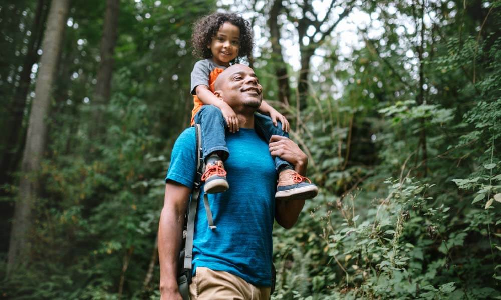 father and son walking through the woods