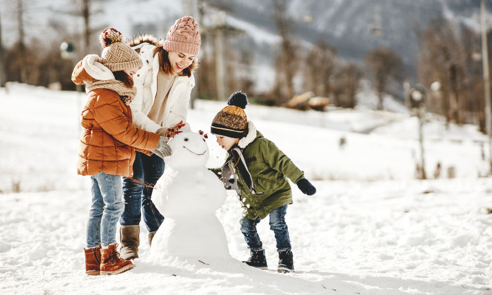 family playing in the snow