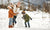 family playing in the snow