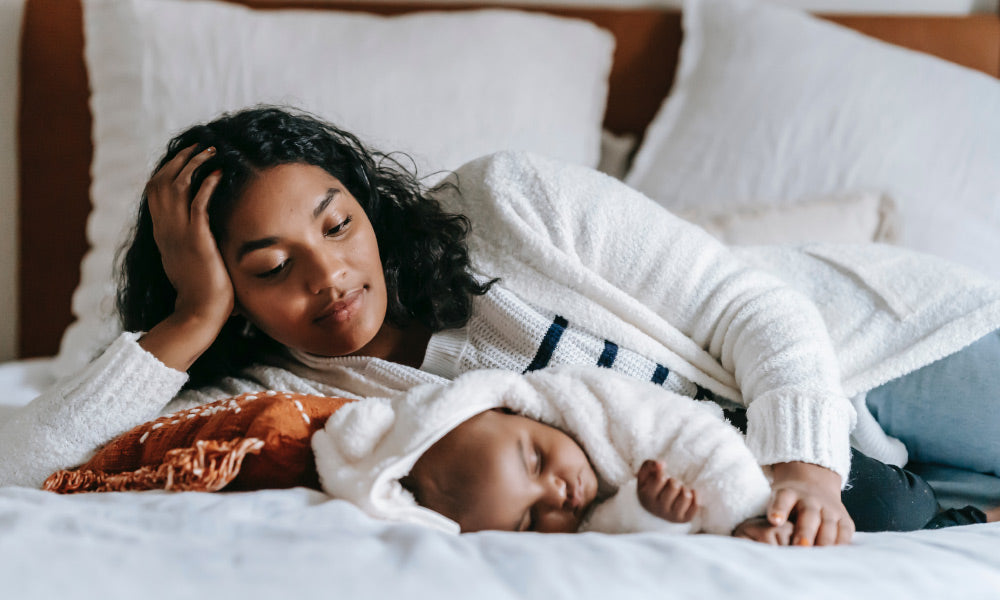 mom and baby pensive in bed