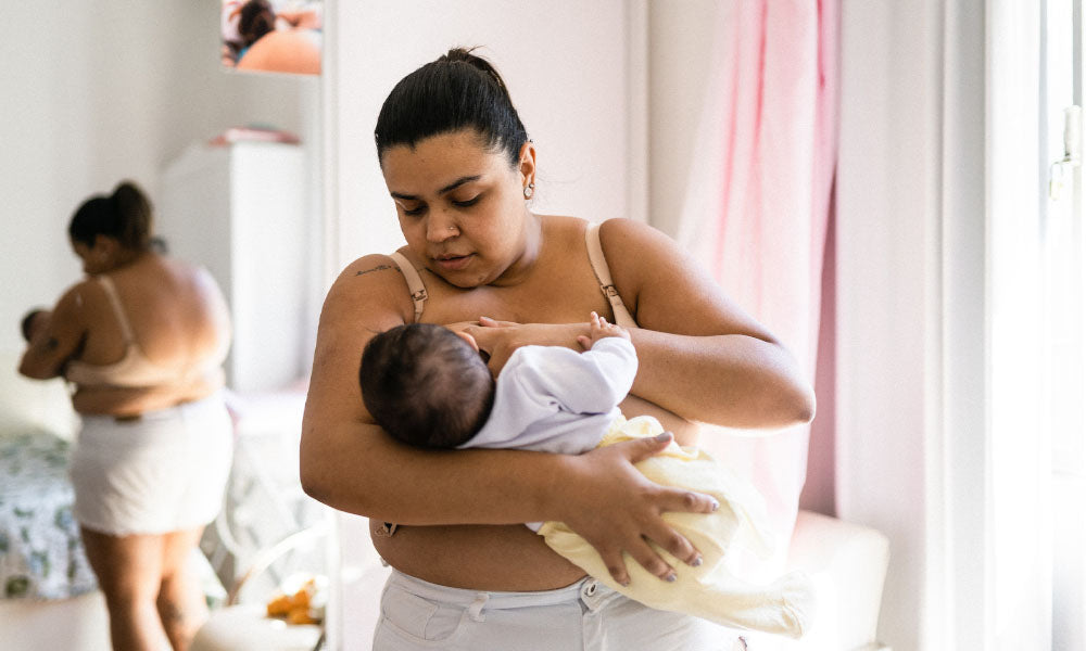 mother breastfeeding in the bedroom