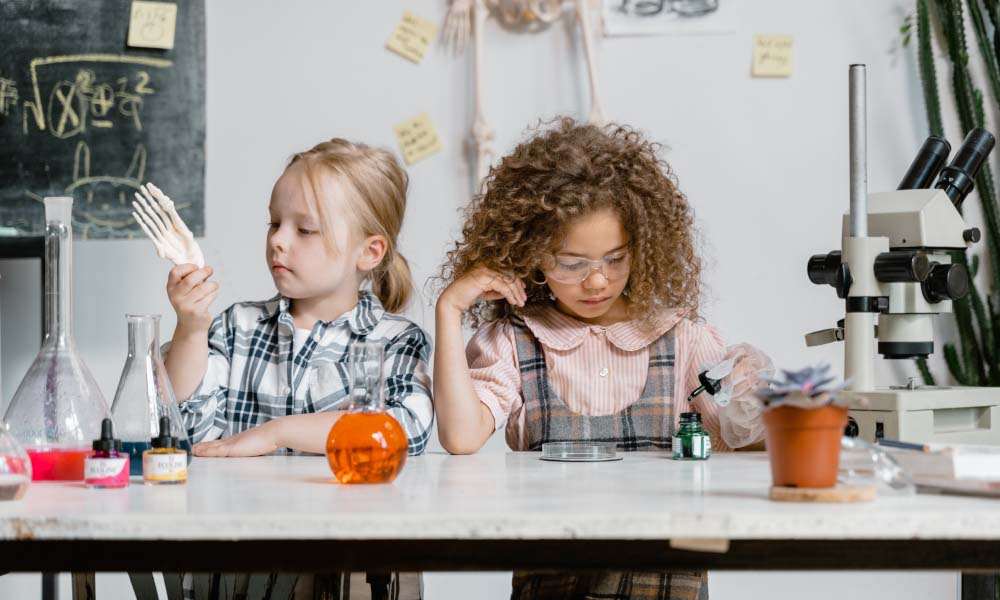 two girls with microscope