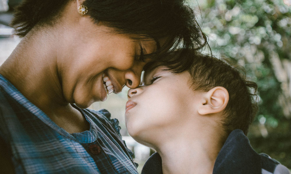 woman and child touching faces