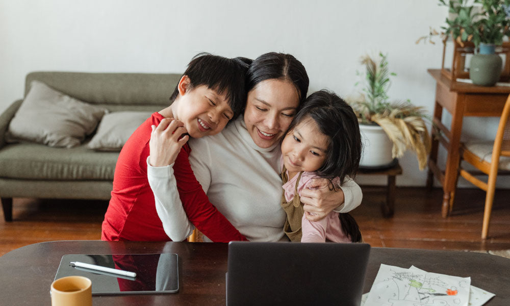 woman with two kids and laptop